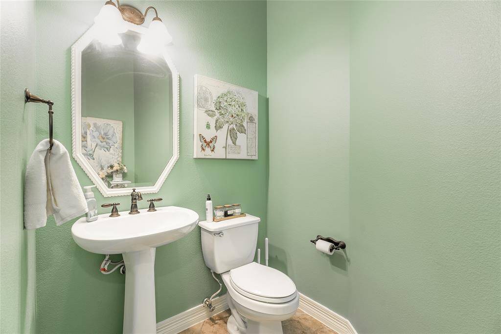 Elegant and roomy downstairs half bath.