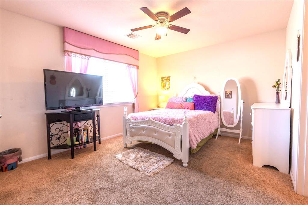 Spacious 1st bedroom upstairs with a walk-in closet and convenient Hollywood bath.