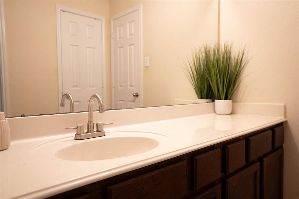 Elegant bathroom sink with sleek fixtures and ample counter space, perfect for a touch of luxury.