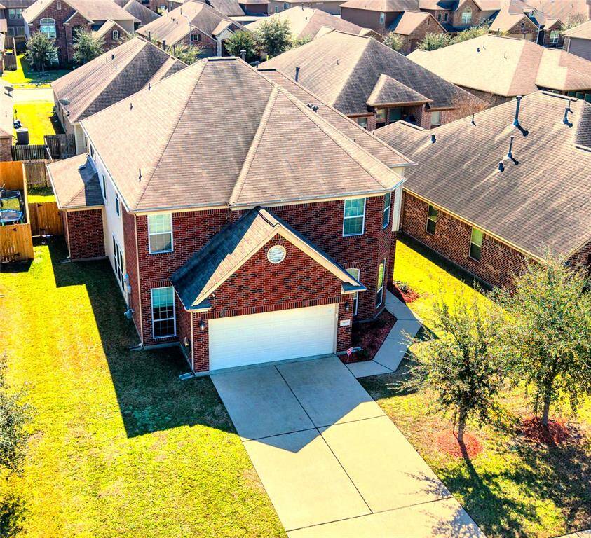 Discover your dream home: a charming two-story brick house with a spacious driveway, nestled in a serene neighborhood.