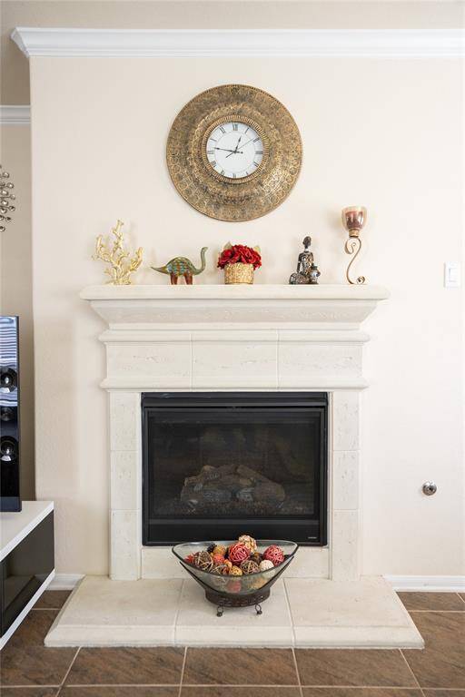 Cozy family room with an elegant stone-mantled gas fireplace.