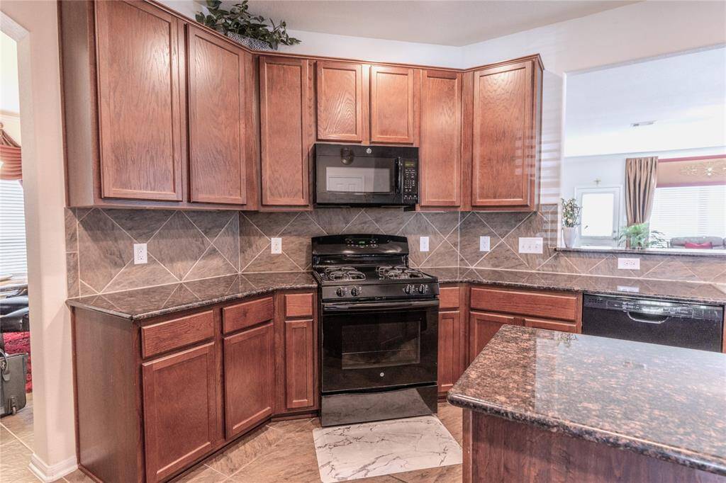 Modern kitchen with a sleek gas range and spacious island.