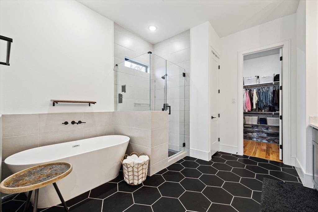 Master bathroom with freestanding soaking tub, walk in shower, spacious vanities and walk in closet
