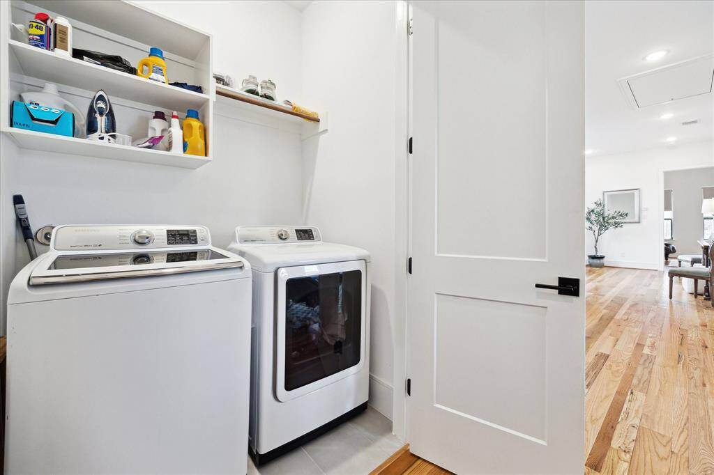 Second floor laundry room with hanging rack and shelving