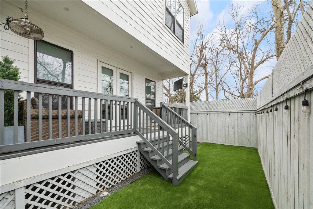 Fenced backyard with turf. Nice size porch with TV and ceiling fan.