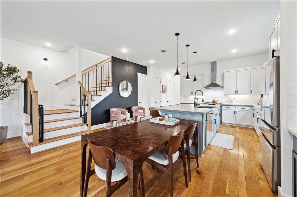 Spacious kitchen with large island, stainless steel appliances, bar area with wine fridge. Wood floors throughout!
