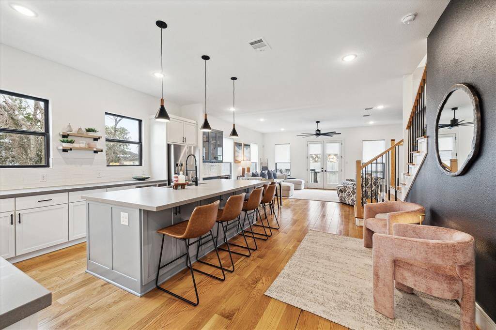 Open kitchen, dining and living room. Painted accent wall and kitchen island, and walk in pantry. Soft close drawers and doors!