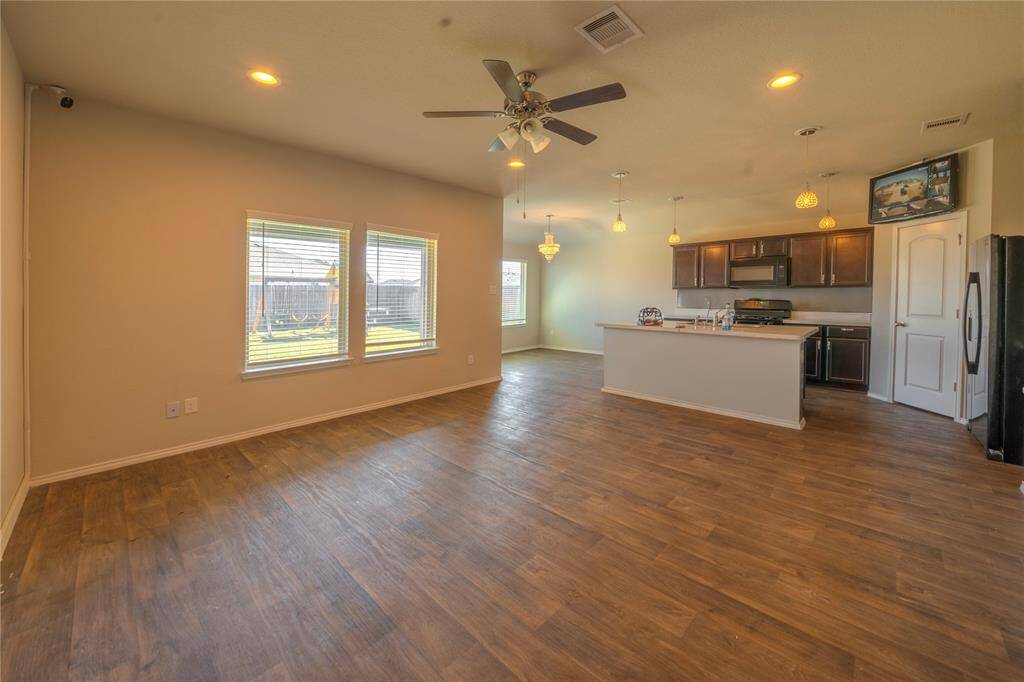 View of the kitchen that opens to the living area, great for gatherings.  security cameras stay.