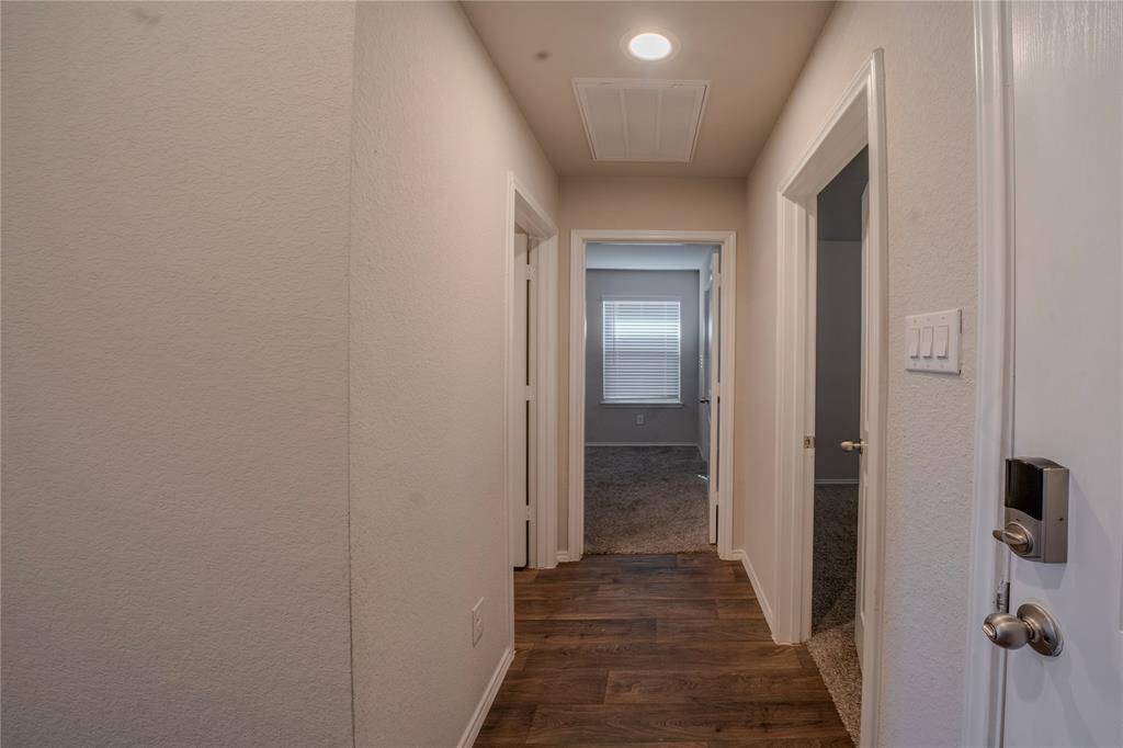 View from the front door to the right as you enter. These are two secondary bedrooms and to the left is the secondary bathrom.