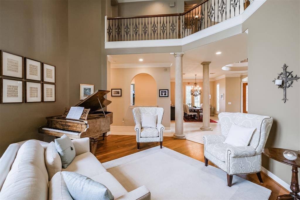 The formal living room has a gallery overlooking it from the second floor.
