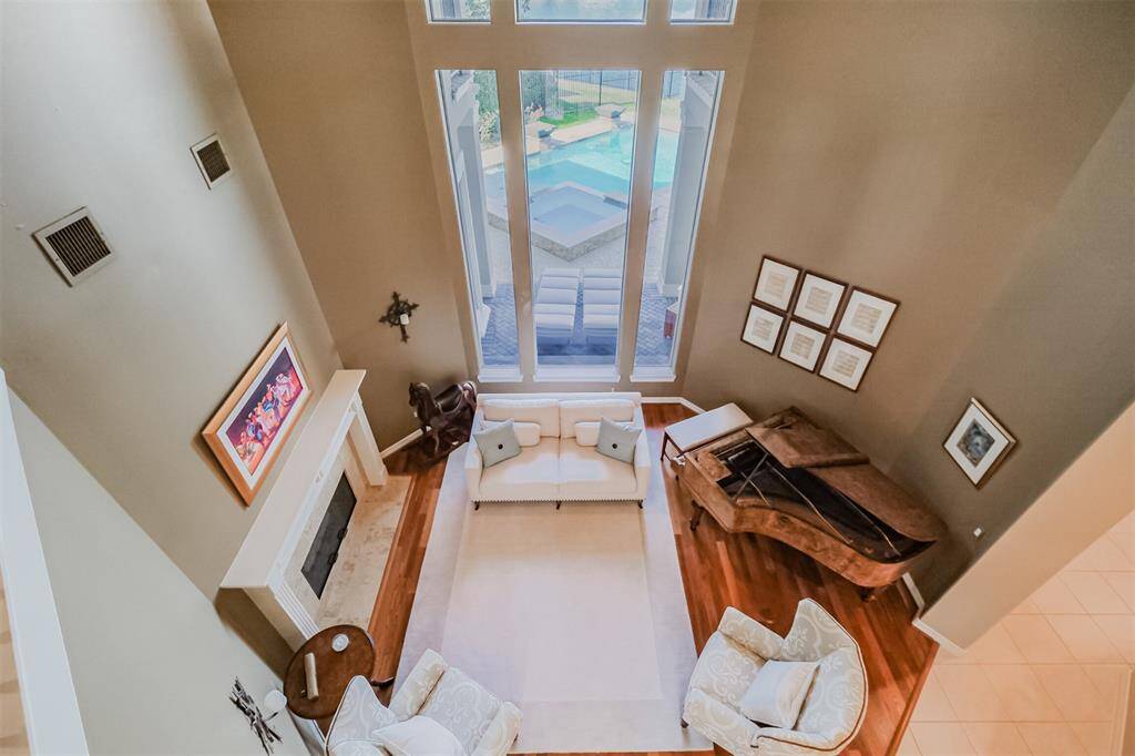 Wow! The view from the second floor highlights the tall ceilings and wonderful views from the windows. Light a fire for you and your guests to enjoy in this elegant formal living space.