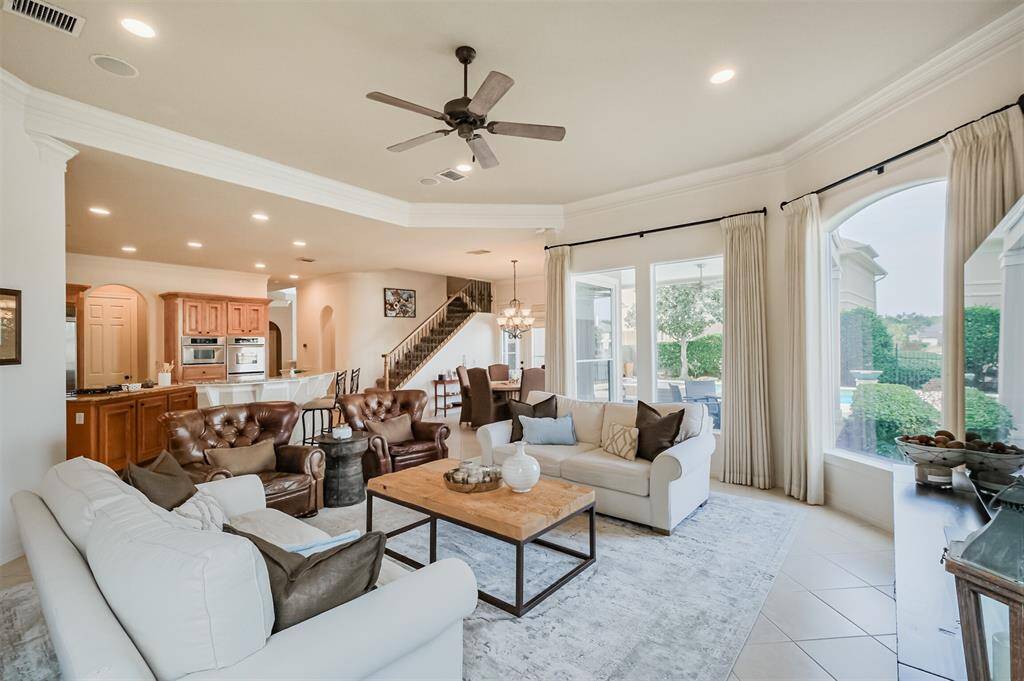 Open to the kitchen and breakfast room this family room is light and bright & has a wall of windows with lake views