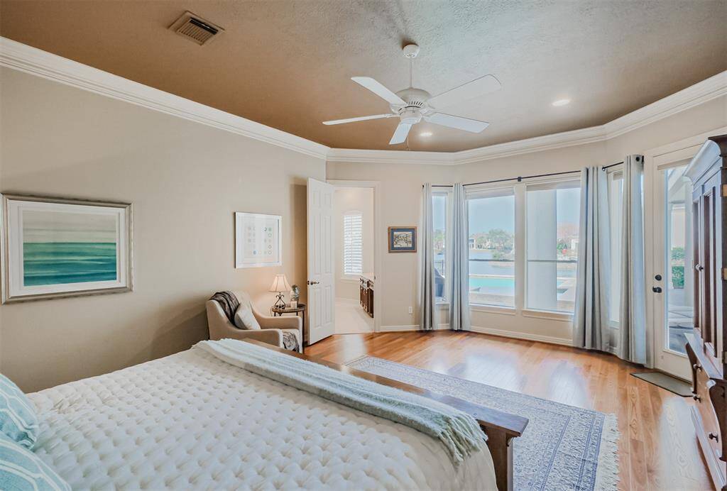 Welcome to the primary bedroom. Take in the pleasing views of the pool and outdoor space