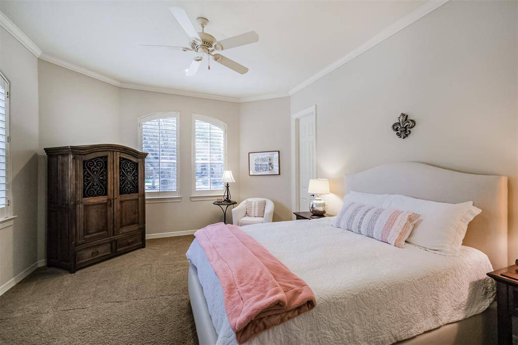 The 2nd downstairs bedroom is a spacious, elegant retreat featuring soaring ceilings, neutral paint tones and a large walk-in closet.