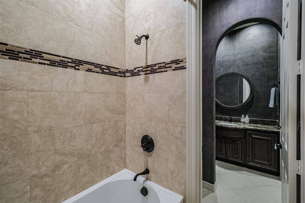 Secondary en-suite full bath in the additional downstairs bedroom.