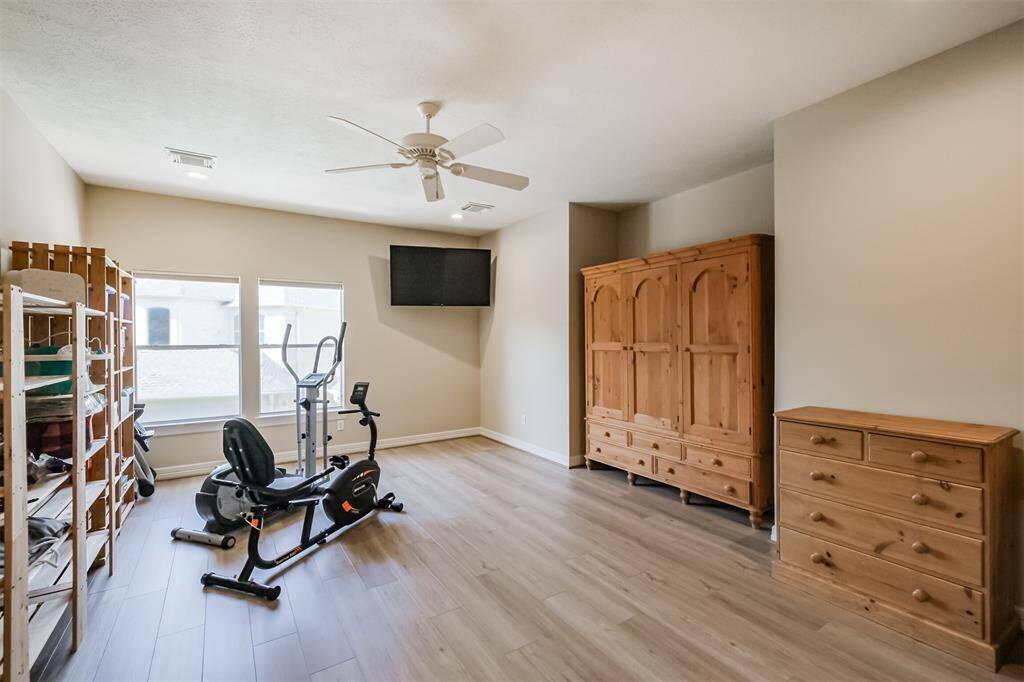 The newer flooring in bedroom #4 of 4 upstairs makes for a carpet free, allergy friendly room. The current owners have this room set up as a home gym. The wooden wardrobe will stay for closet space.