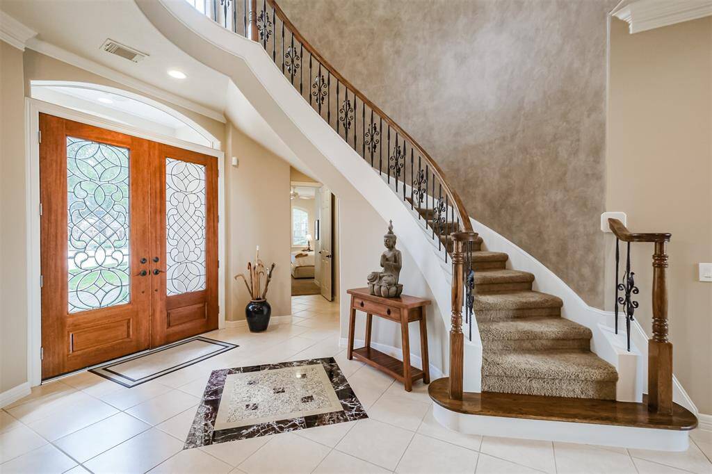 impressive two story entry greets you as you enter the home.