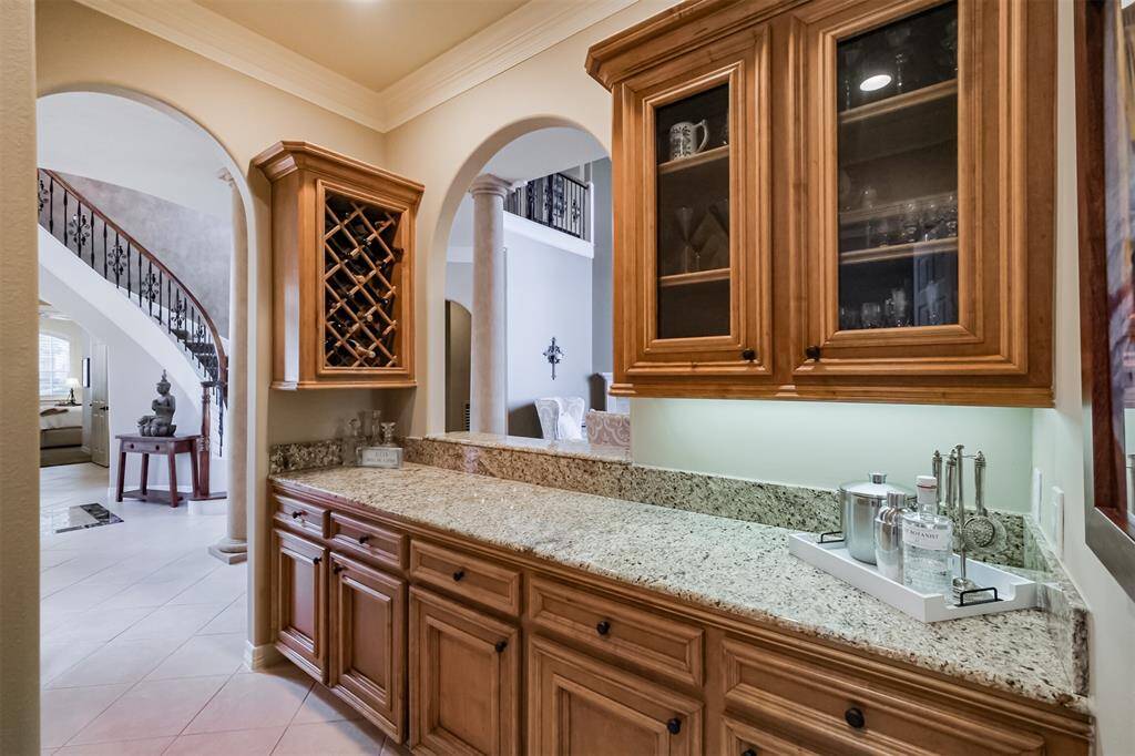 Large butlers pantry with tons of storage, surface space and display cabinets connects the kitchen to the dining room to make serving a breeze!