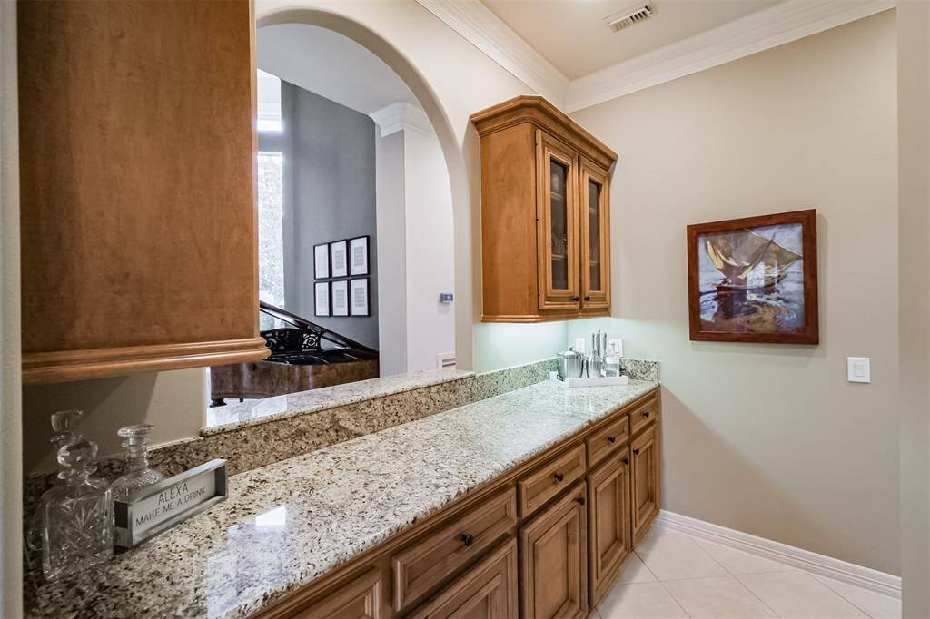 Open to the formal living room, the bar area makes the perfect place to serve guests while hosting parties.