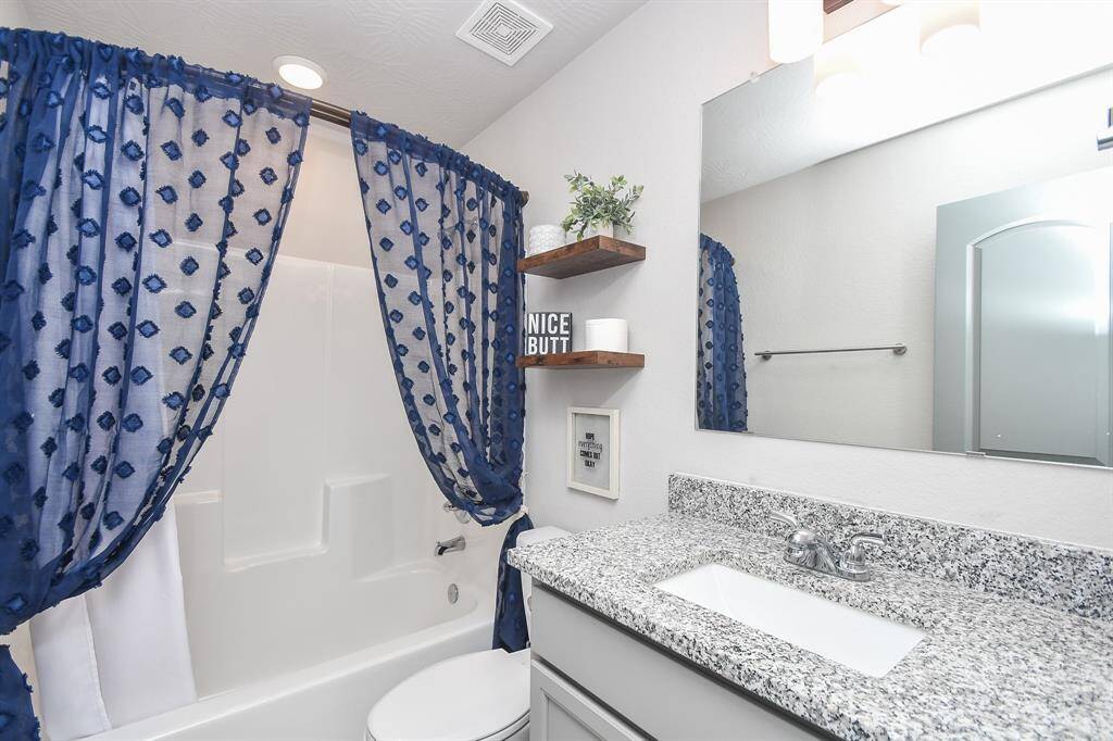 Secondary bathroom blends functionality with character, offering a cozy and inviting feel.