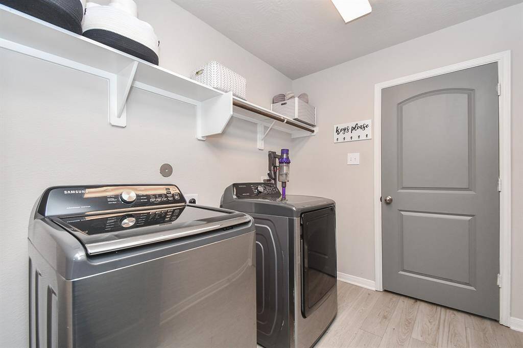 A well organized laundry room is a dream! This space offers a rod and shelf above that provides ample storage.