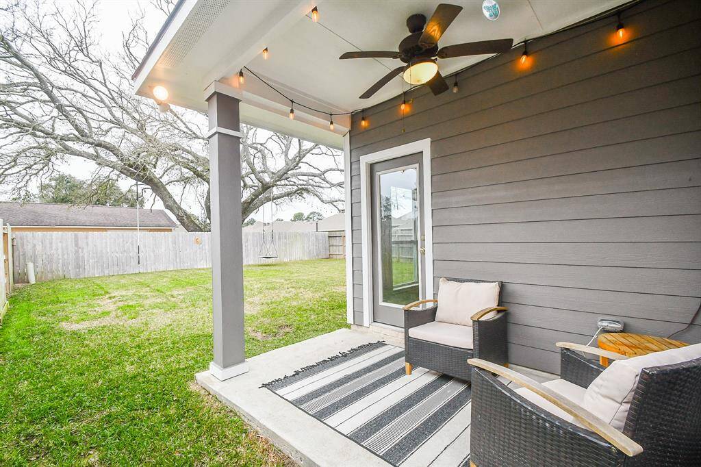Inviting covered patio exiting to large backyard making it a perfect spot for relaxation or outdoor play.
