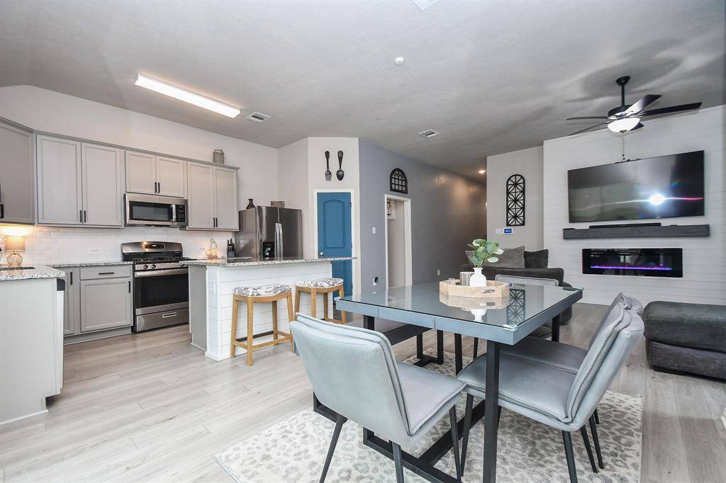 A beautifully designed open-concept living space that seamlessly blends the living room, dining area, and kitchen.