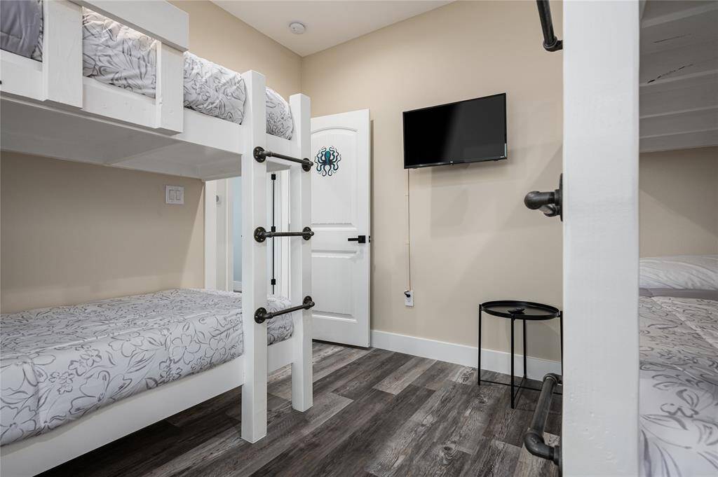BR 3: The bunk room is equipped with a wall-mounted TV.