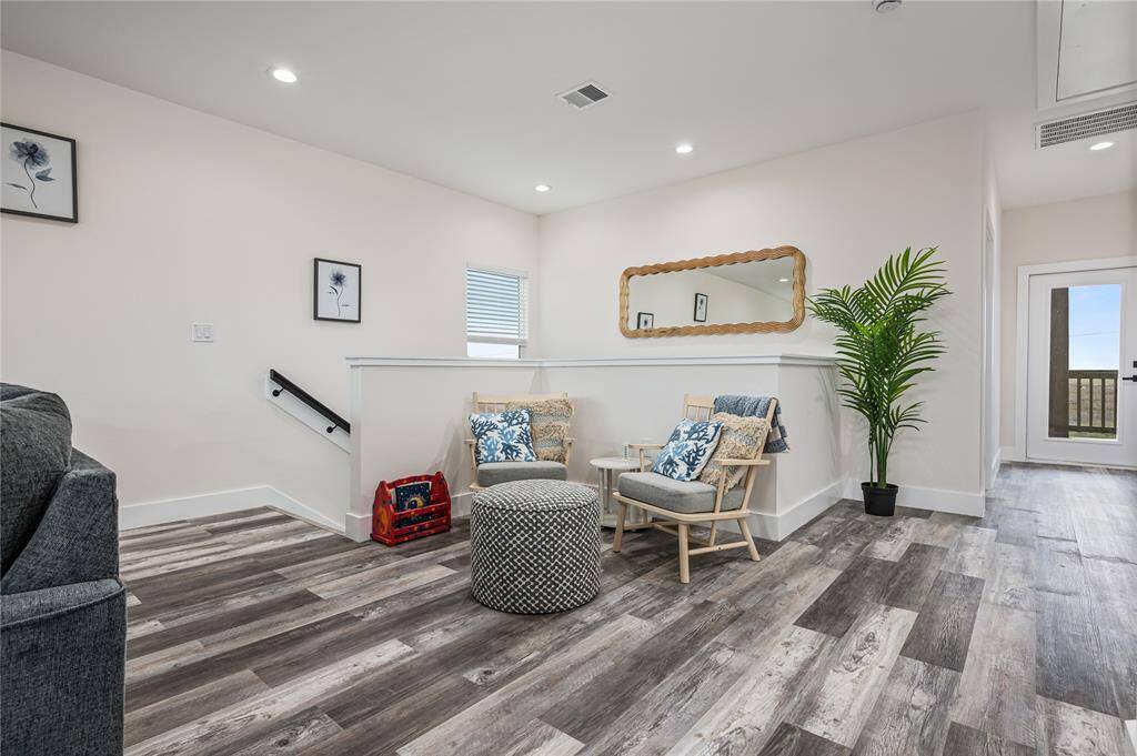 Have a conversation in this seating area at the top of the stairs.