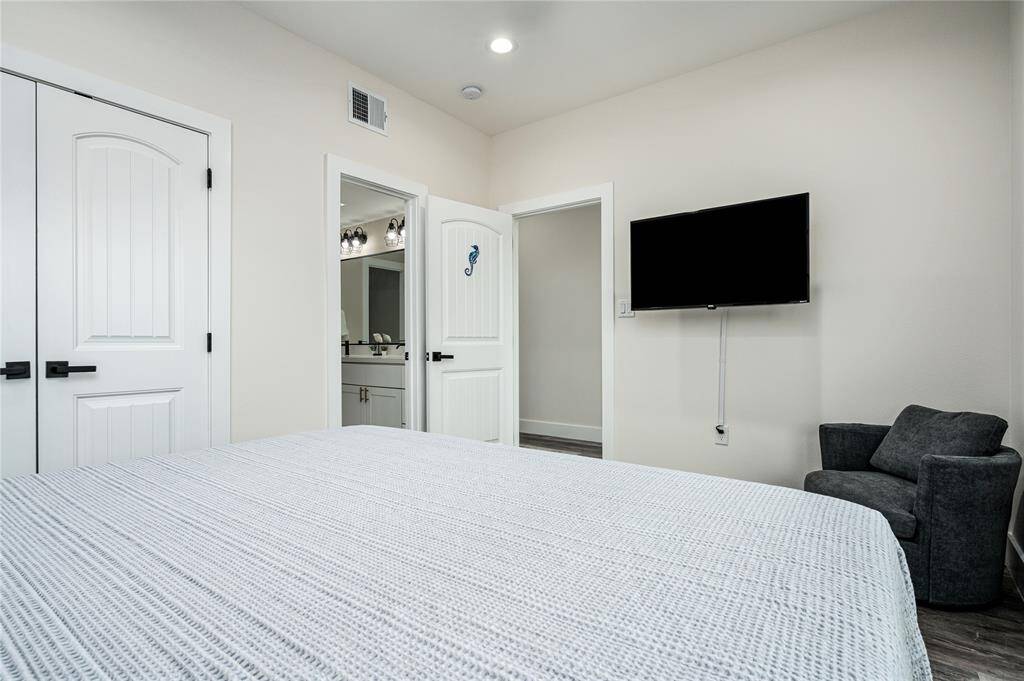BR 5: Spacious bedroom has high ceilings, ceiling fan, and LVP flooring.