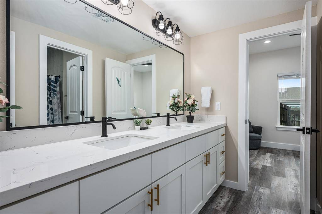 Br 5: This full bathroom can also be accessed from the hallway and has two vanities with quartz countertops.