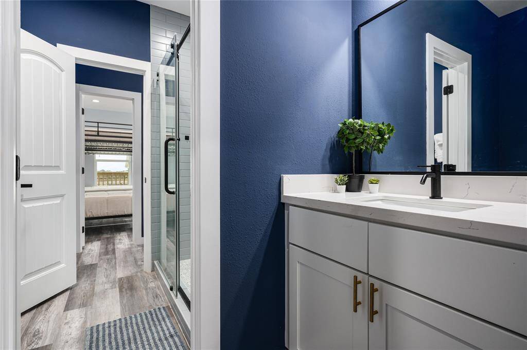 Bath 3: Jack-and-jill bathroom offers separate vanities and toilets with a separated, shared shower.