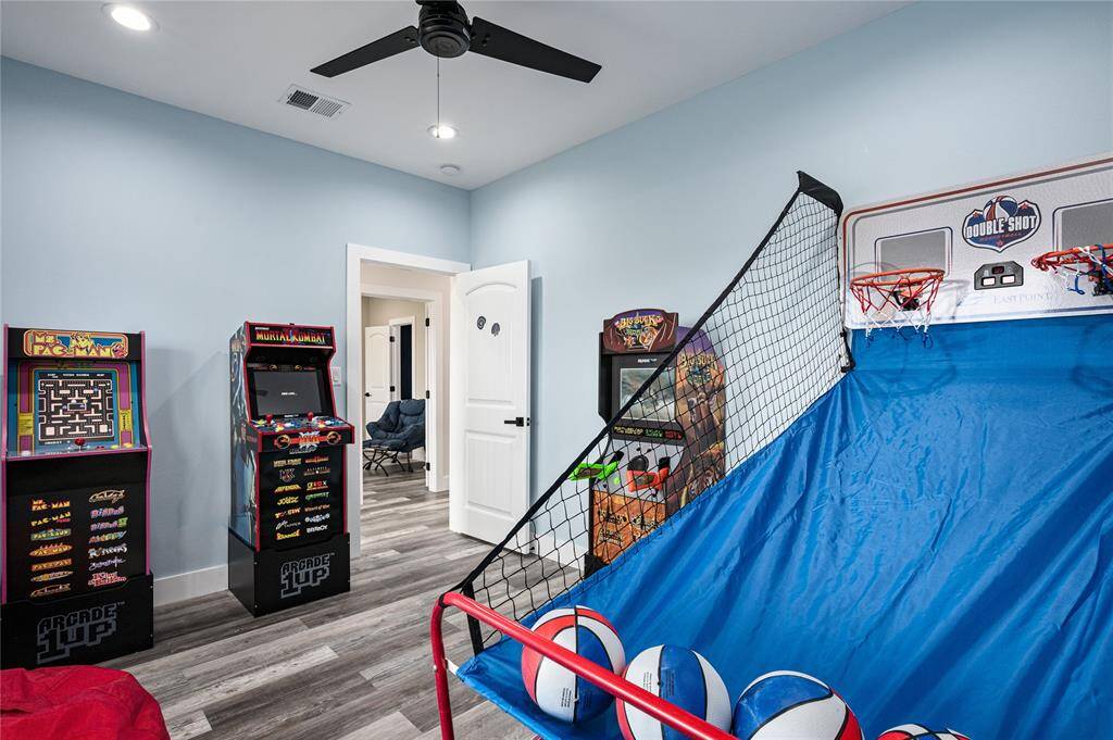 BR 2: This bedroom is currently being used as a game room, as it's adjacent to the living and other common areas.