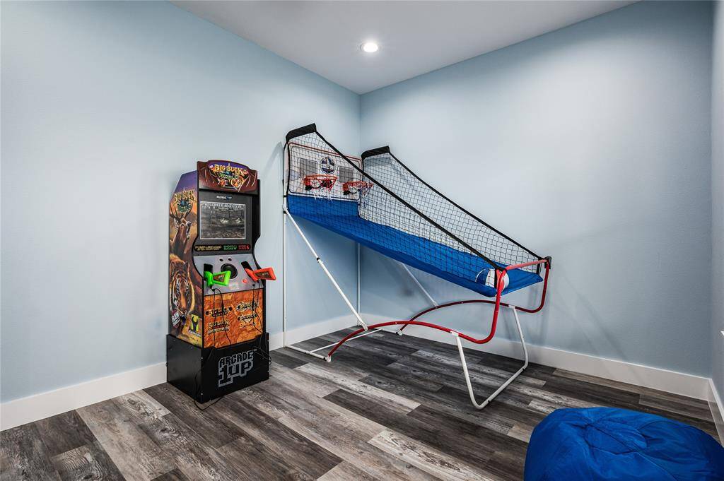 BR 2: The game room features multiple arcade games to entertain a crowd.