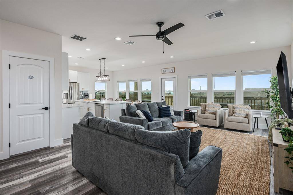 In this reverse floorplan, the common areas, primary suite, and a secondary bedroom are situated on the second floor to take best advantage of the Gulf views.