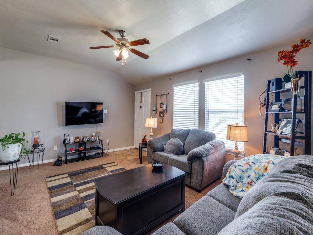 "The living room is spacious and well-lit with plenty of natural light."