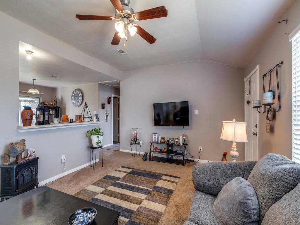 The living room has neutral paint and is open to the kitchen, making it a perfect space for entertaining family and friends.