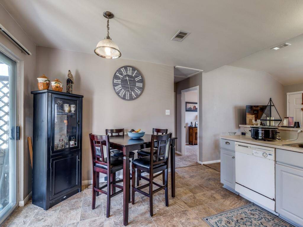 The hallway leading to the secondary bedrooms is adjacent to the eat-in kitchen breakfast area in the split floor plan.