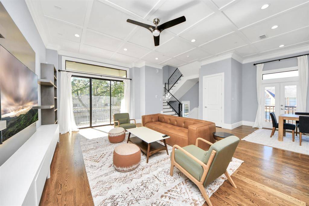 Family room flooded with natural light through the expansive windows.