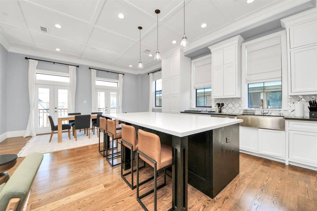 This kitchen is by far any chef’s dream! This spacious kitchen features high ceilings, white stained wood cabinets, granite countertop, SS appliances, modern tile backsplash, recessed lighting, extended counter space, granite kitchen island, and space for breakfast bar, and a walk-in pantry all overlooking your huge family room.