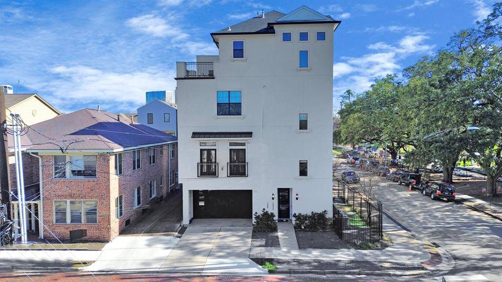 This contemporary masterpiece boasts a sleek, eye-catching facade with clean lines, bold architectural details, and elegant black accents.