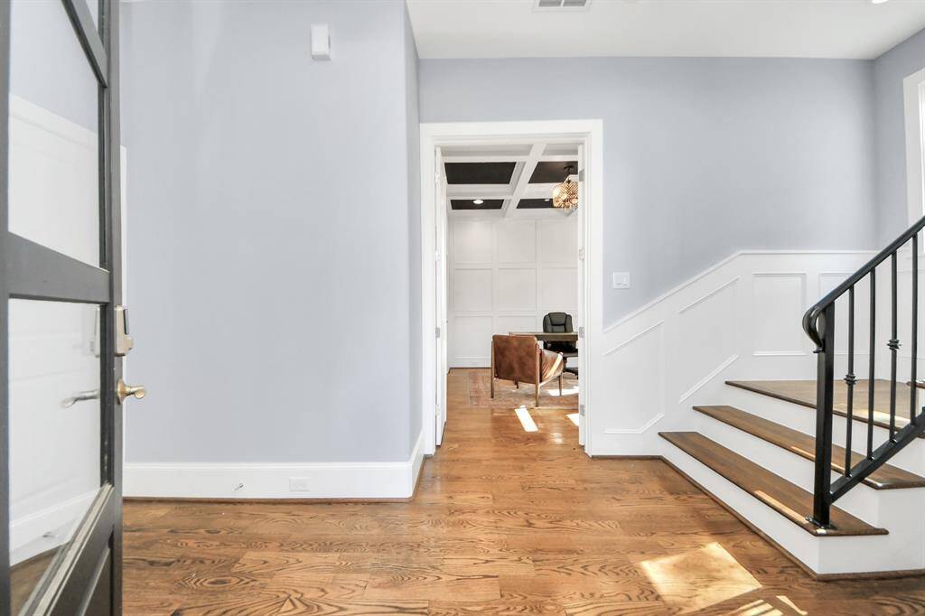 As you step into the threshold of this luxurious home, you'll soon be welcomed by an elegant glass door. Inside, soaring ceilings amplify the space.