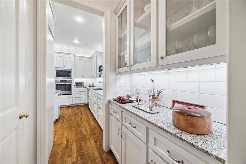 Butler's pantry features a large walk-in pantry and connects the kitchen to the formal dining room