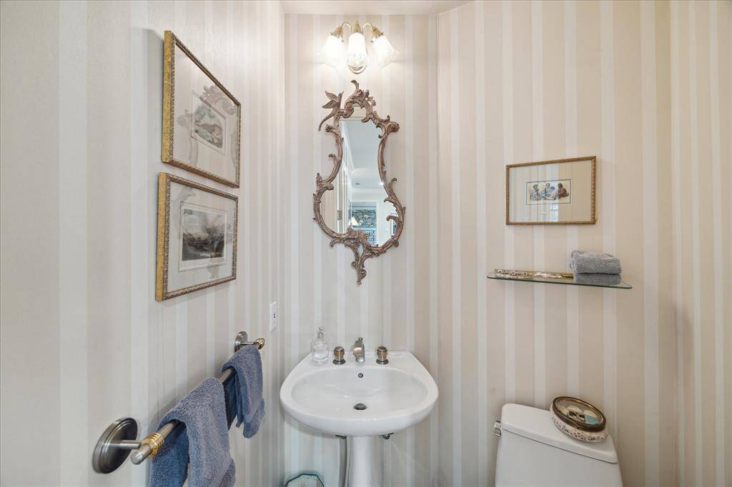 Formal powder room is tucked away off the den