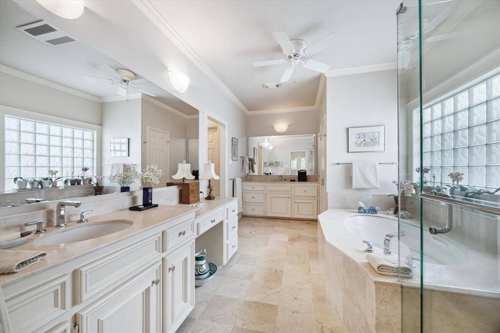 Large primary bath with double vanities, oversized jetted tub, and separate shower