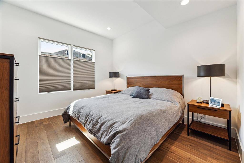 Great for guests, the first floor bedroom suite features engineered hardwood flooring, recessed lighting, double windows, and a spacious closet.
