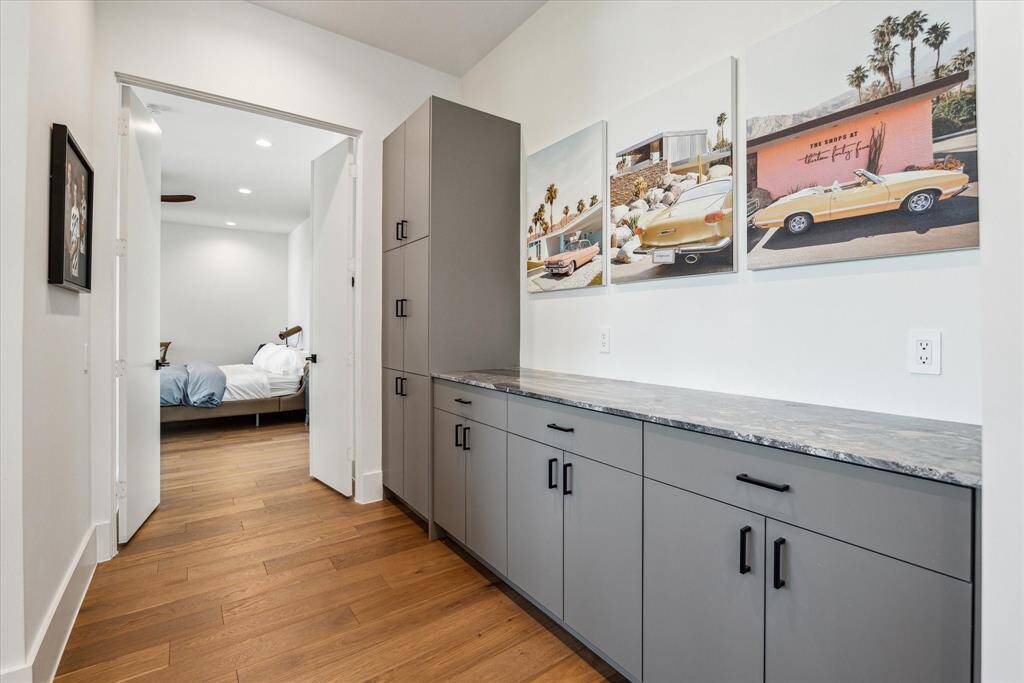 A welcoming view of the morning bar at the entry to the primary bedroom. The morning bar features quartzite counters and provides storage for the study located just to the left.