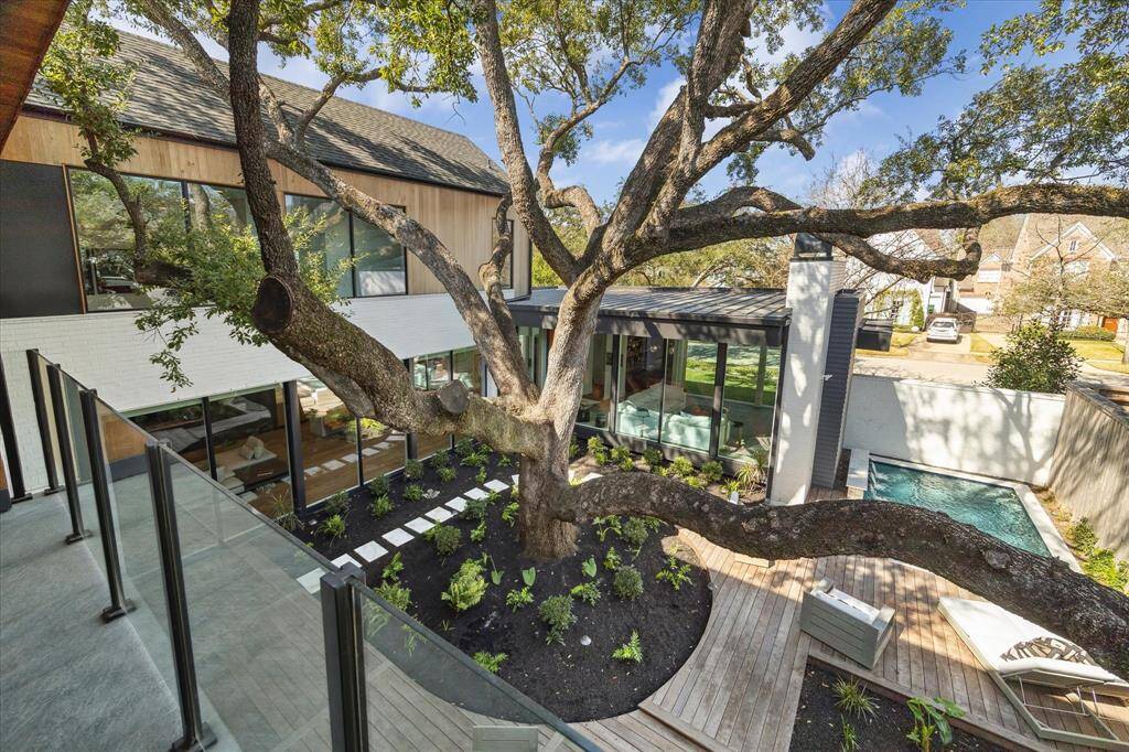 Wake up to breathtaking views from the primary bedroom’s private balcony, overlooking an incredible outdoor oasis designed for relaxation and entertainment.