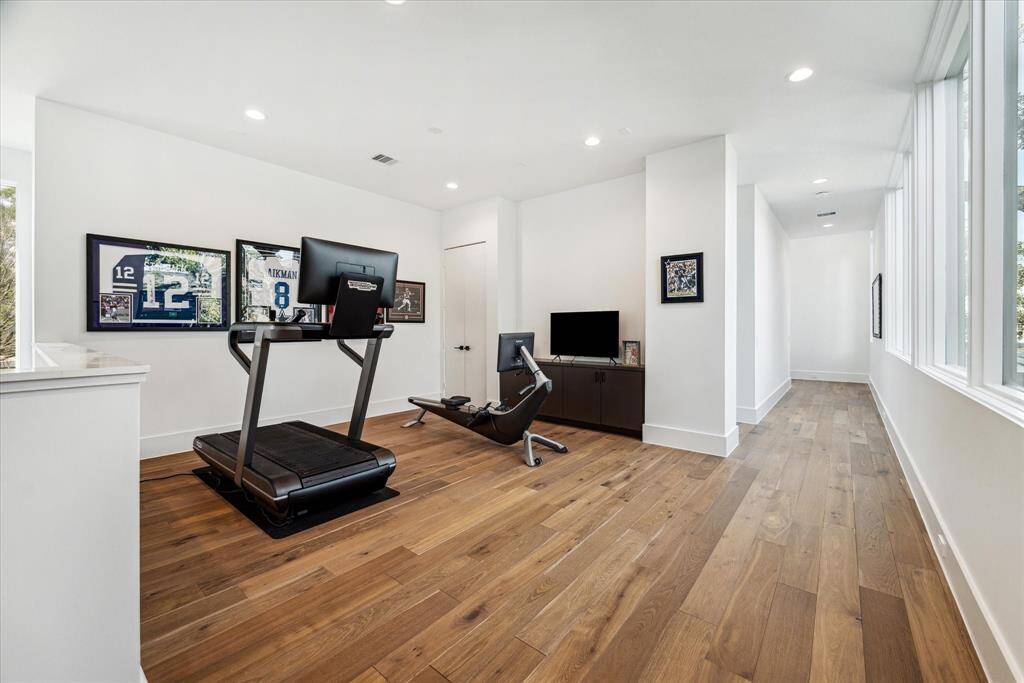 Located at the second-floor landing, this open game room offers an additional versatile living space. Featuring a built-in media area and a spacious closet, it's the perfect spot for entertainment, or a personalized hangout.