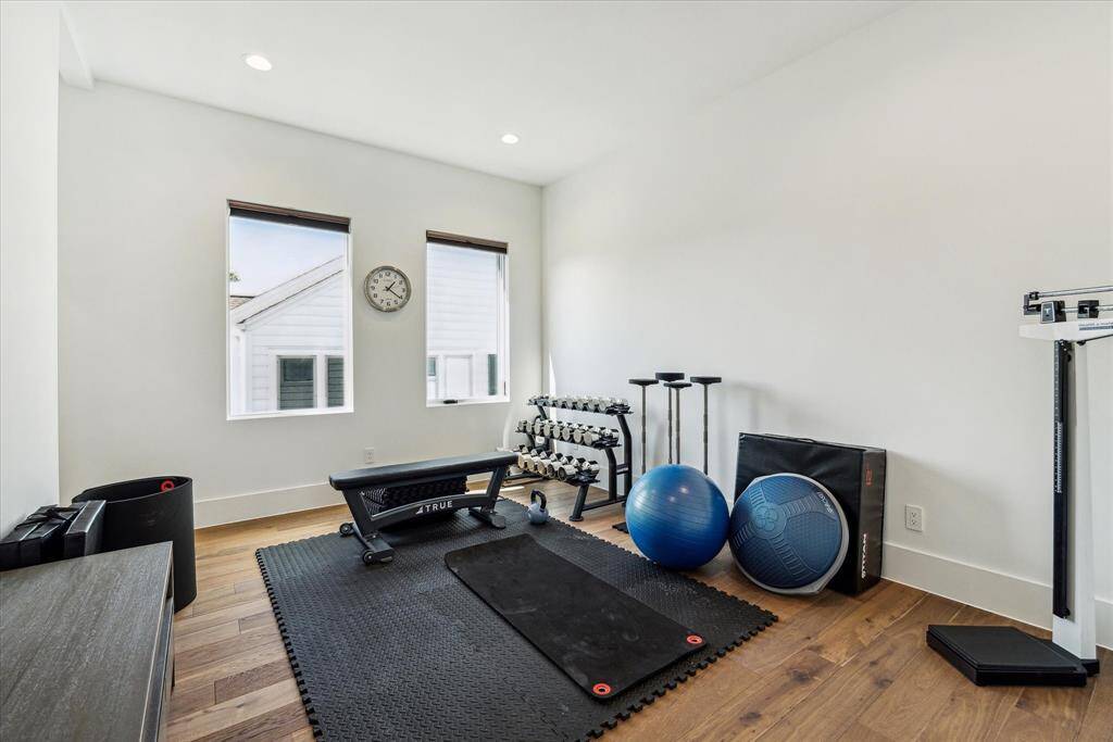 Bedroom #3 is currently utilized as a workout room and features wood flooring, recessed lighting, large windows and a walk-in closet.